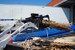 Blue Diamond Mini Skid Steer Root Grapple Attachment transporting pallets and lumber