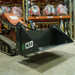 The CID Mini Skid Steer 4-in-1 Bucket Attached Front Left Side Angle
