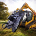 Severe Duty Bent Axis Brush Cutter on skid steer lifted.