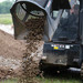 Skid Steer Screening bucket dumping out rocks after finishing the job