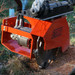 Grinding a Douglas fir stump with Eterra's mini skid steer stump grinder