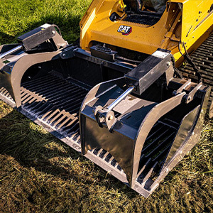 closeup top angled shot of a cid skid steer heavy duty grapple attachment on grass