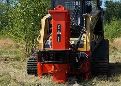 Back view of the Eterra flamethrower attached to a skid steer shooting flames out of the front