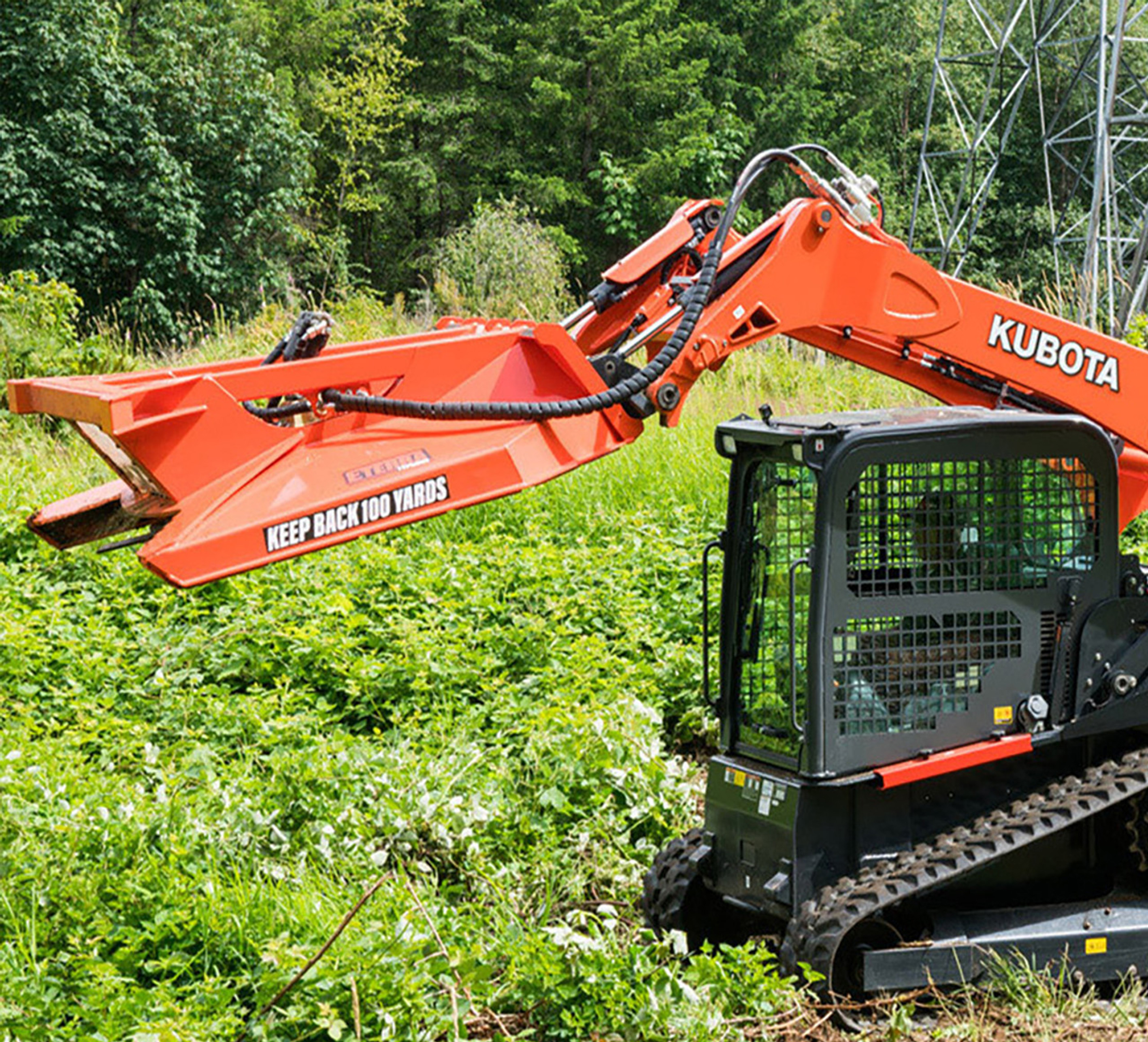 side view of a skid steer parked in a forested area with an eterra  typhoon clearing mower attachment on the fronted, lifted 