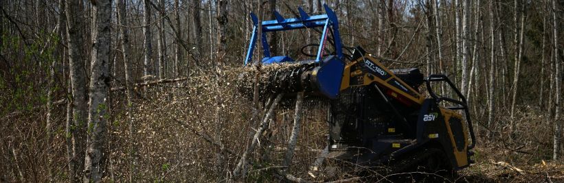 Promac Skid Steer Forestry Mulcher asv skid steer mulching a tree in some dense woods