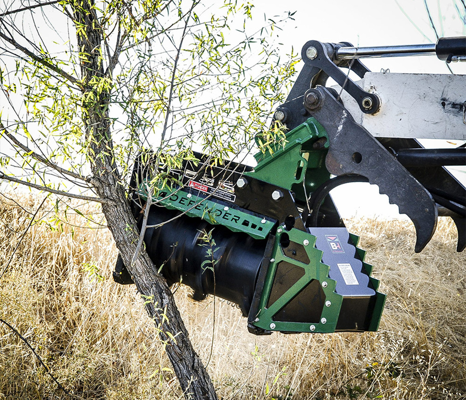 closeup shot of the valley tool excavator fx26 forestry mulcher attachment behind a sapling 