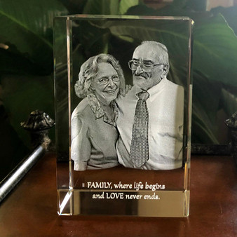 Crystal Print Anniversary Rectangular 3D Photo Crystal Block, engraved with a black and white photo of a happy elderly couple, with an engraved message at the bottom that says 'FAMILY, where life begins and LOVE never ends.'