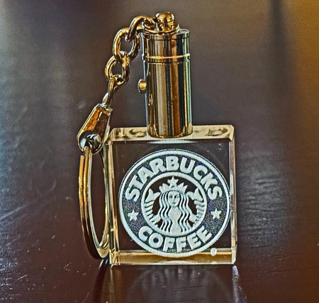 Crystal Print Corporate Promotional Square Crystal Keychain Lighted, a gold-colored keychain with a square crystal containing the Starbucks Coffee logo and a built-in light.