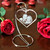 Ornament Stand, a decorative jewelry or photo display stand with a heart-shaped glass ornament engraved with a couple's photo and the message 'I Love You' surrounded by red roses.