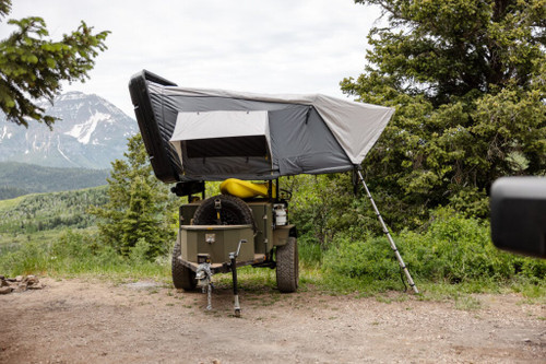 Smittybilt Overland XL Hard Shell Tent atop a trailer, ideal for overlanding adventures.