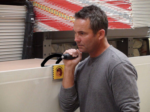 Drywall panel being carried using Gorilla Door Gripper Panel Carrier 44011