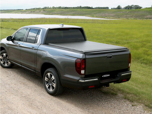 The Access 36039 LiteRider Roll-Up Tonneau Cover is designed for 2017-2024 Honda Ridgeline trucks with a 5' bed, offering protection against water, snow, and dust. Made from heavy-duty, stretch-resistant vinyl, it features an auto-lock latch, slide-lock system, and stay-tight tension control for security and durability. The roll-up design allows full bed access, while the no-drill installation ensures easy setup. Its sleek, low-profile fit enhances truck aesthetics and works with bed accessories for added versatility.