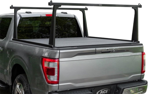 The Access F3010082 Adarac Aluminum Series Bed Rack is a durable cargo solution designed for 5 ft. truck beds. This rack system features a corrosion-resistant matte black finish and anodized aluminum rails, offering a 500 lb. evenly distributed load capacity. It is compatible with most inside-the-rail roll-up tonneau covers and includes easy, no-drill installation with aluminum stake pocket inserts. The versatile, aerodynamic design allows for quick repositioning and secure cargo attachment using integrated mounting channels.