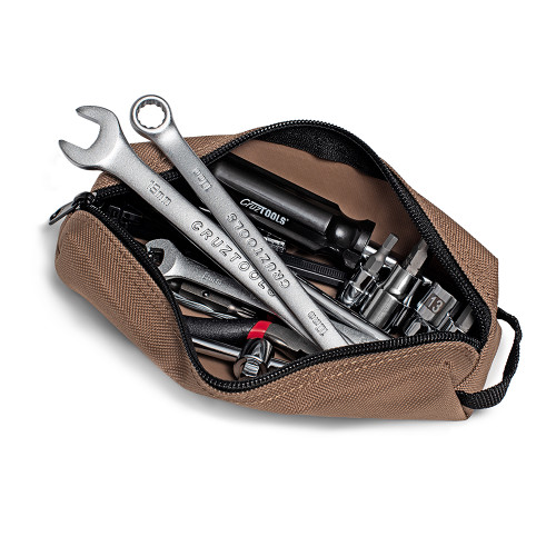 A brown bag filled with tools and items from the Switchback Compact Dirt Bike Tool Kit.