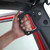 A hand gripping a car door handle, illustrating the Smittybilt Black Aluminum Grab Handles designed for secure handling.