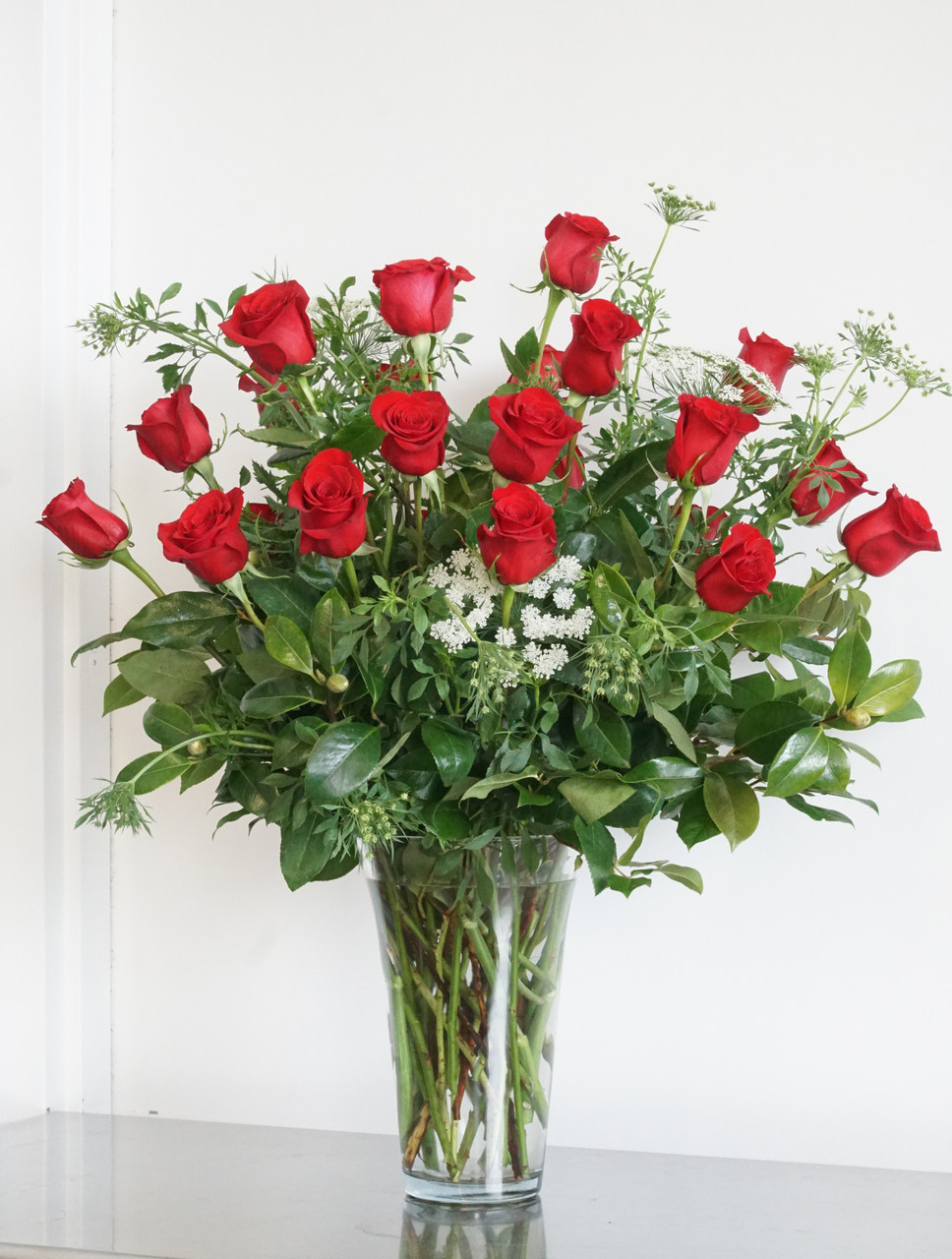 classic wrapped bouquet of roses with lush greenery