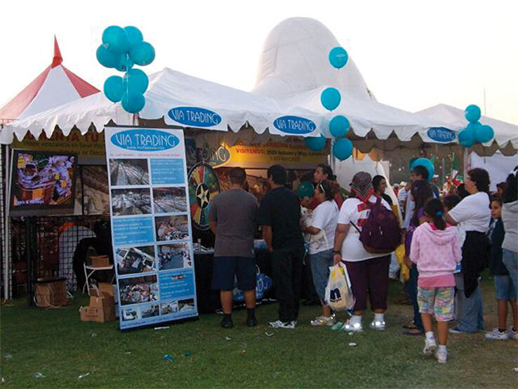 Community members lining up at Via Trading Booth to Learn More about Reselling at a community event