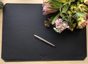 Black leather desk mat - monogrammed.  Pen is for display purposes only to show a sense of scale. Black leather desk mat - monogrammed.  Pen is for display purposes only to show a sense of scale.