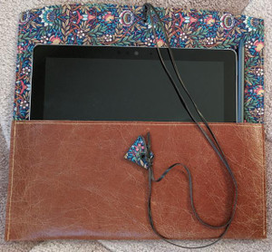 Leather Satchel with Liberty of London Peach Porter Lining. Handmade in Australia. Genuine leather. Cognac coloured leather shown here. Holding Microsoft Surface Go. Will fit ipad Pro and smaller.