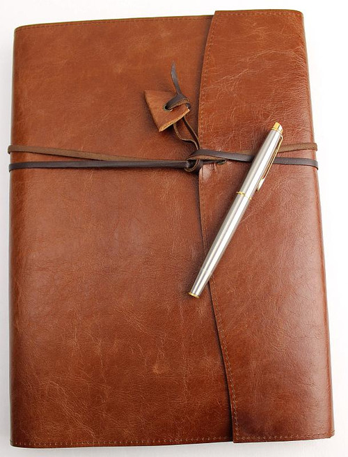 The Book Wrap A4 size is handcrafted in Australia from quality genuine leather. A kangaroo leather wrapping strap holds contents in place.