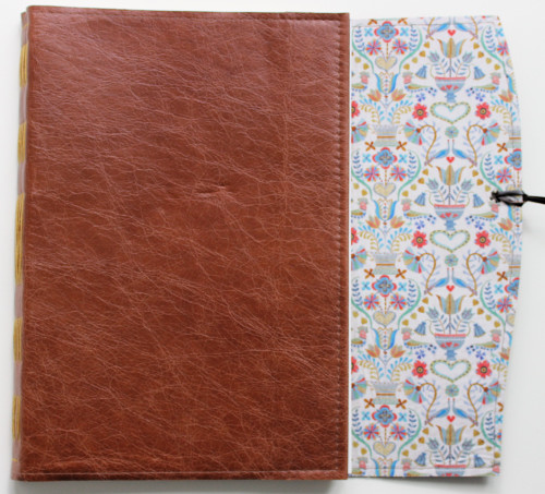 A4 Cognac Handstitched journal.  Lined with Lovebirds print from Liberty of London. 