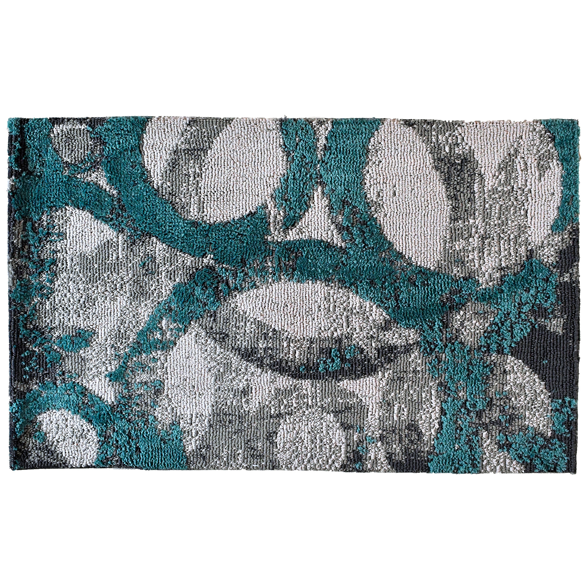 Rings of teal and gray intertwine on this Simple Spaces by Jellybean® accent rug. Artist Michael Mullan’s selection of two complementary colors on a layered, intricate design will bring depth to your room. This accent rug is available in two sizes for additional placement options.