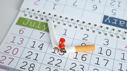 Broken cigarette pinned to a date on calendar