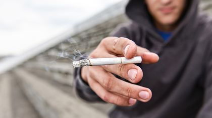 A man is holding cigarette
