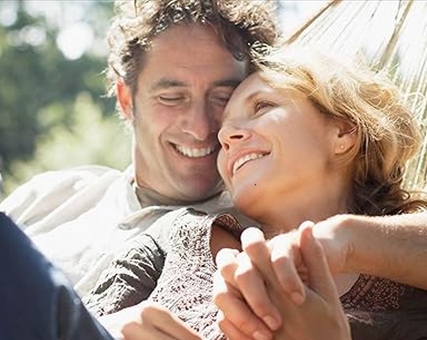 A couple relaxing on a hammock