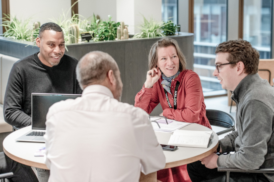 a group of people discussing at a table.