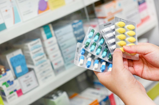 A pharmacist with meds in stripes