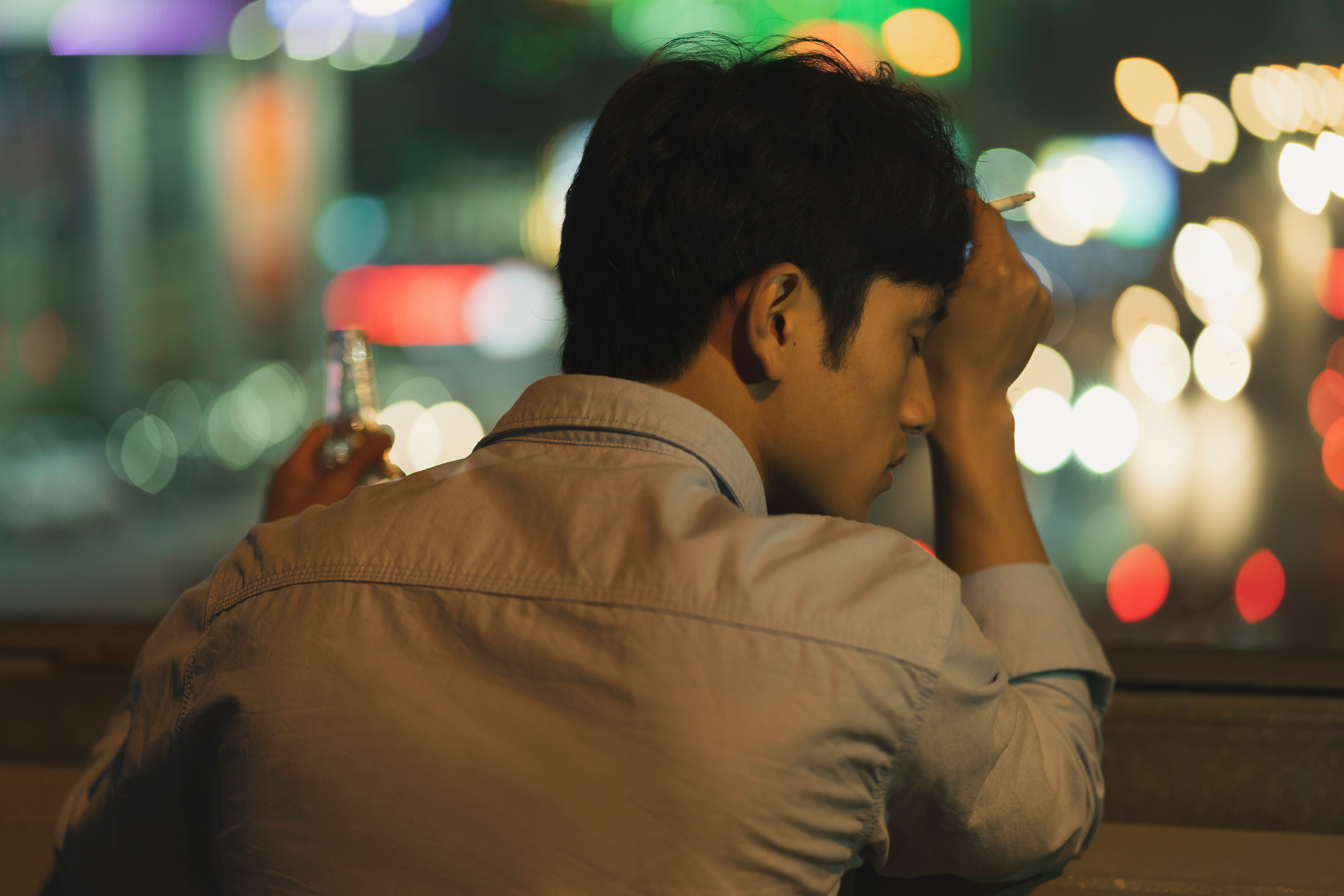 Tired man holding a cigarette