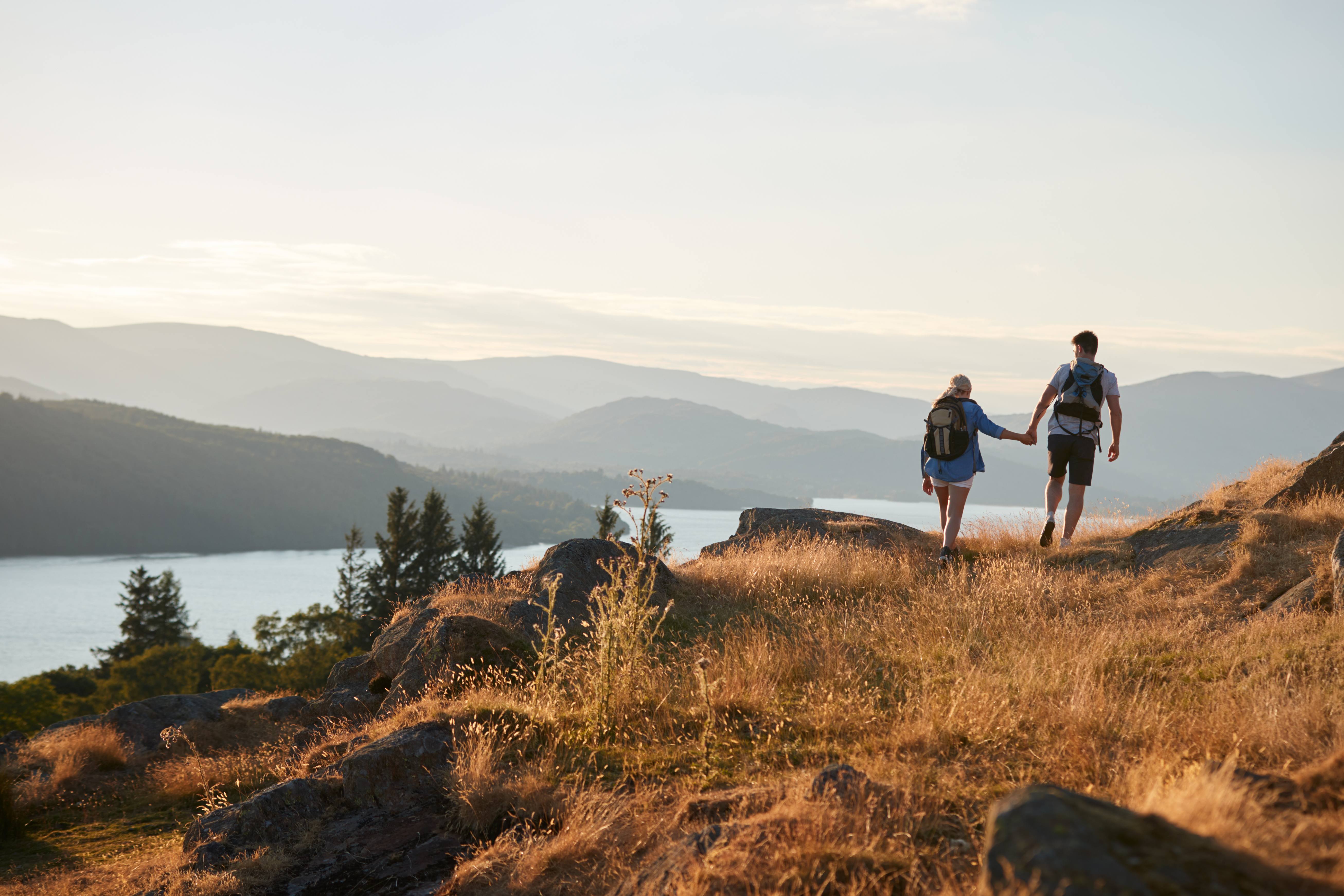 Healthy couple hiking near a lake 