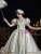 Champagne vintage dress highlighting the elegant puffed sleeves and soft satin fabric
