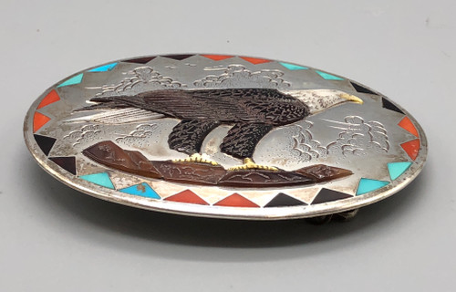 eagle themed inlay belt buckle, carved feathers, claws and mountains, coral, turquoise and onyx