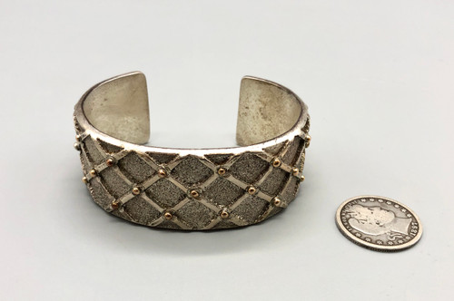 sterling silver and gold bracelet by award winning artist Edison Cummings, conjoining X like fashion with brushed background for texture