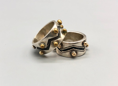 his and hers sterling silver and gold rings by award winning artist Edison Cummings, geometric design with a darkened silver background, 14K yellow gold