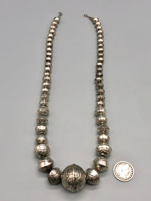 vintage Navajo pearl necklace, graduating sizes, conjoined by silver findings and strung on a link chain