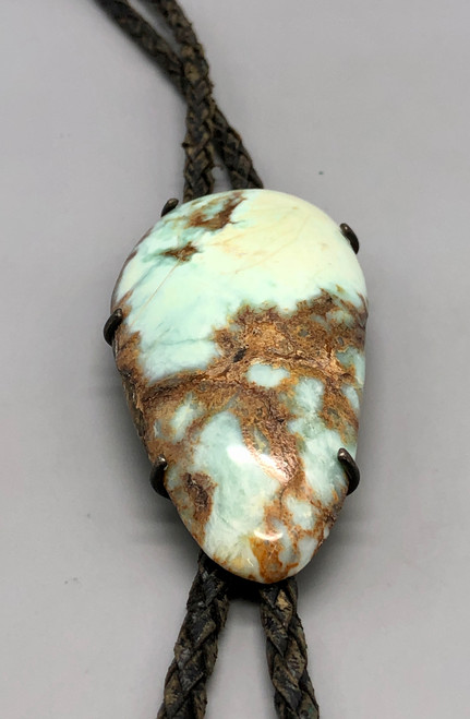 pale green turquoise bolo tie, large, oval shaped, pale green turquoise stone setting in a silver backing with "claw" holders