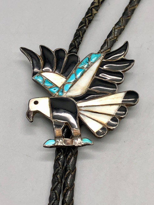 eagle inlay bolo tie, inlay of turquoise, mother of pearl, and onyx in a flying eagle design, braided black leather cord, custom sterling silver tips