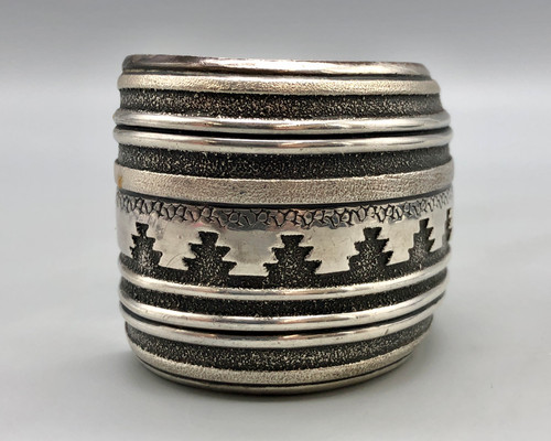 wide sterling silver bracelet by Thomas Singer, multi-layered, darkened stippled background, rug pattern