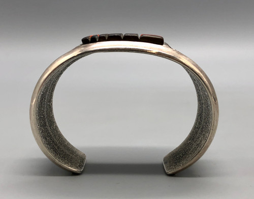 tufa cast and cobblestone inlay bracelet by Navajo artist, Harrison Jim, cobblestone inlay of wood, turquoise, onyx, and coral, geometric designs