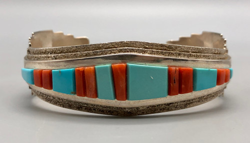 sterling and cobblestone inlay bracelet by Navajo artist, Harrison Jim, cobblestone inlay of turquoise and coral, brushed background