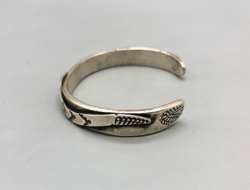 vintage ingot bracelet with snake theme, silver applique along the cuff with intricate filework, hand stamped designs