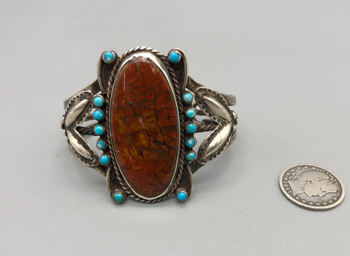 circa 1940s satellite bracelet, petrified wood setting with snake-eye turquoise cabochons surrounding it, sterling silver