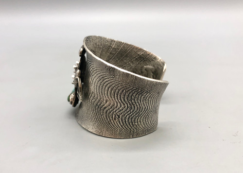 unique Hopi sterling silver tufa cast bracelet, stylized, three dimensional Kachina motif with a turquoise cabochon affixed to the nice tufa cast