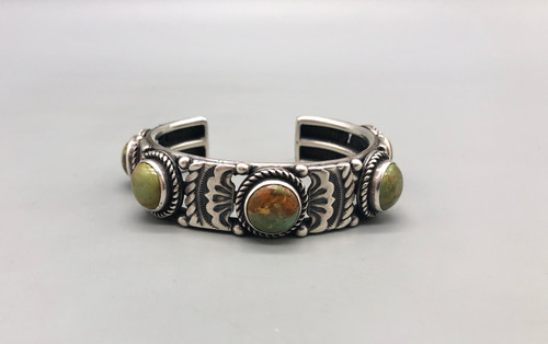 nice sterling silver and five-stone turquoise bracelet, five turquoise cabochons with a loop of twisted wire, filework and hand stamped designs