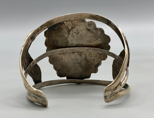 a larger green stone, silverwork of twisted wire