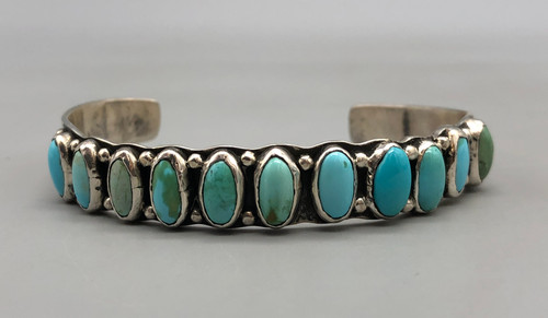eleven natural turquoise cabochons in a row