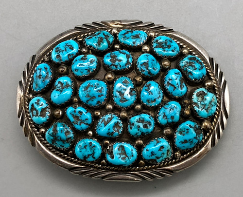 27 turquoise cabochons set in wonderful clusters, surrounded by silver dots, and twisted wire